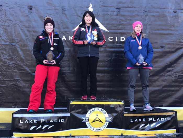 Skeleton athlete Mun Rayoung (center) celebrates her gold medal atop the podium on Jan. 21 at the IBSF North American Cup, in Lake Placid, New York.